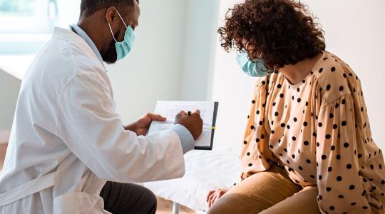 Doctor treating patient wearing face masks